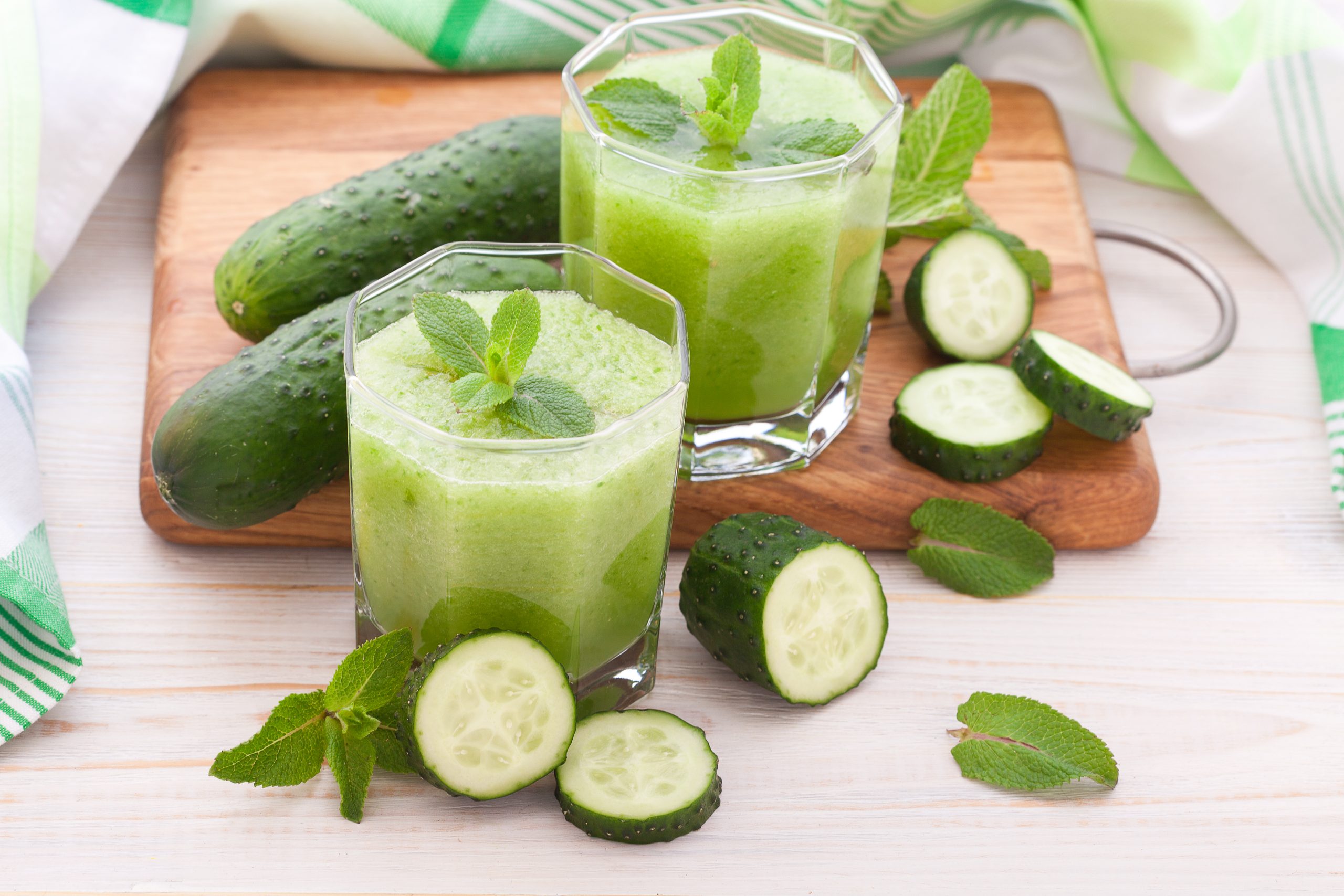 Cucumber,Juices,And,Vegetables,On,White,Wooden,Table